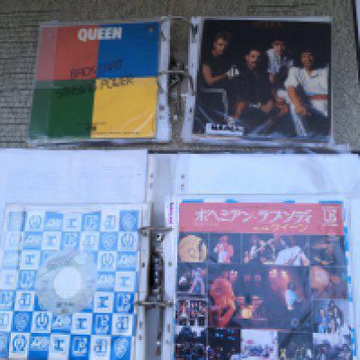 A box containing four binders of Queen 7" singles comprising foreign pressings including Japanese, US, Brazil, Yugoslavia and more plus fanclub only exclusive editions.