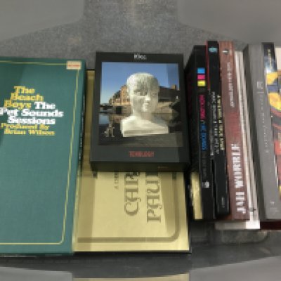 A box of CD box sets by various artists including Marc Bolan, Scott Walker, The Beach boys and others.