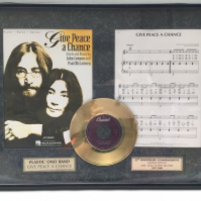 A framed and glazed limited edition gold disc display commemorating the 25th anniversary of 'Give a Peace A Chance' by Plastic Ono Band, comes with COA, approx 61.5cm x 46.5cm.