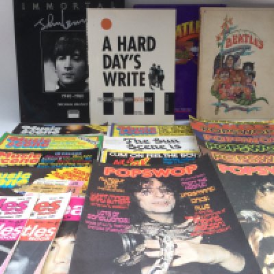 A case of music ephemera including a signed Slade publicity card, press photos, vintage music publications including NME, Sounds, Popswop, Beatles books including a 1969 'Beatles Illustrated Lyrics' by Alan Aldridge and other items.
