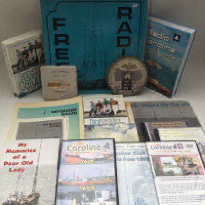 A collection of Radio Caroline memorabilia including signed books, photos, RNI promotion and jingle tape reel and other items.