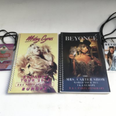 A Beyonc̩ World Tour 2014 tour itinerary booklet and all access tour laminate plus a Miley Cyrus 2014 European tour itinerary booklet and all access tour laminate.