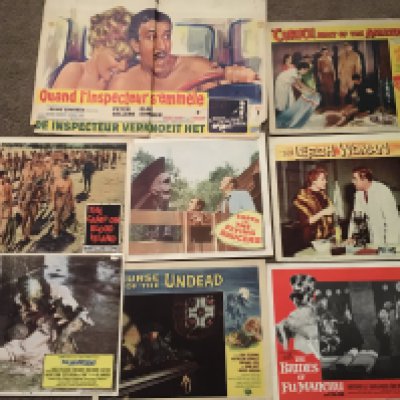 A box of film memorabilia comprising a Belgian one sheet of 'A Shot In The Dark', various lobby cards, a signed display of Olivia De Havilland (Gone With The Wind) etc.