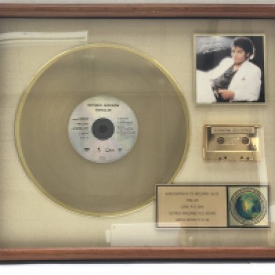A framed and glazed limited edition gold disc, CD and cassette display in recognition for worldwide sales of the Thriller album by Michael Jackson. Number 5/60. Approx 53cm x 43cm.