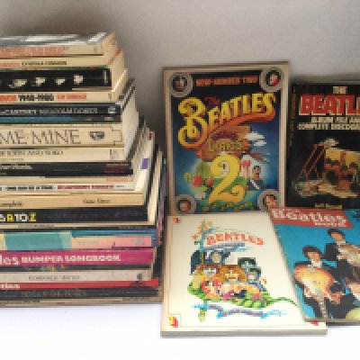 A box of books about The Beatles including 'I Me Mine', 'Illustrated Lyrics 1 & 2', Philip Norman's 'Shout!' and others.