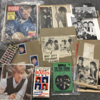 A box of music memorabilia including an Elton John autograph, Debbie Harry autograph, Beatles scrapbook pages, John Peel press photos, magazines, books etc.