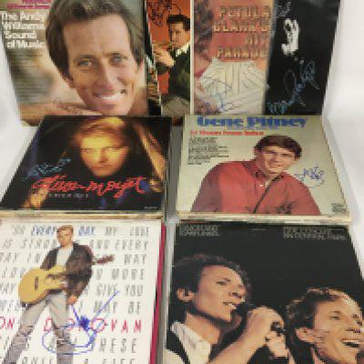 A collection of signed LPs by various artists including Art Garfunkel, Alison Moyet, Cliff Richard, Jason Donovan, David Essex, Andrew Lloyd Webber and others.