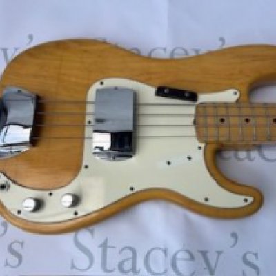 A 1973 all original Fender Precision Bass Guitar in natural finish with white pick guard aged to cream. Light crazing to body consistent with age and use. Light edge wear to neck. Comes with original case. Overall very good + condition.