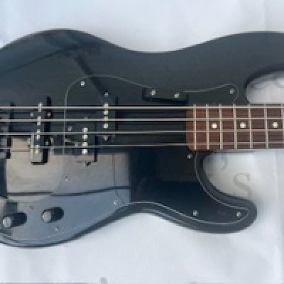 A Fender PJ Bass Guitar with Duff McKagan type Body in Black and changed pickups. BADASS BASS III Bridge in Black. Player's grade. Condition fair to good. Some evidence of play wear to body and repaired damage to edges of headstock. Comes with Hiscox Liteflite Bass Case