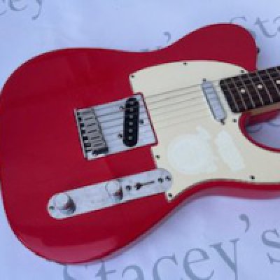 A 2000 USA Fender Telecaster Electric Guitar in fiesta red. Some fading to pick-guard and missing switch tip. Otherwise good condition overall with no major damage and little playwear or tarnishing to frets or brightwork. Comes with non original hard case.