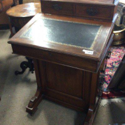 An Edwardian walnut Davenport with a hinged sloping top the sides with a flight of drawers.- NO RESERVE