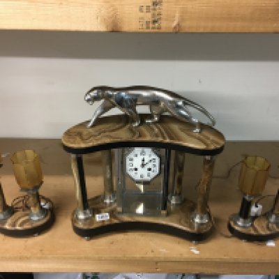 An art deco style marble panther clock with garnitures.