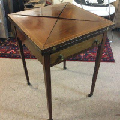 An Edwardian envelope card table , dimensions 72cm tall . Extended top length and width 73x73cm closed 52x52cm approximately .