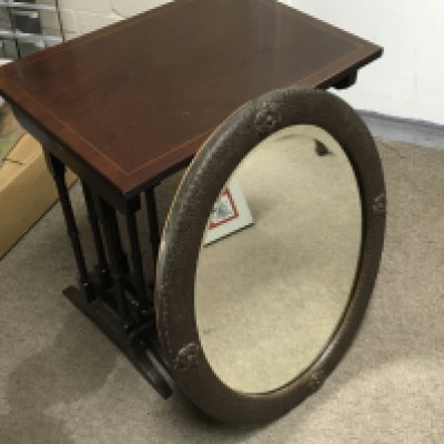 An oval oak framed wall mirror with a nest of mahogany tables. 54cm tall 52cm wide