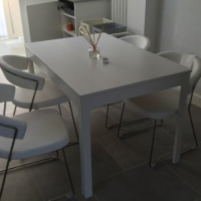 A set of four modern white faux leather and steel kitchen chairs. (4)