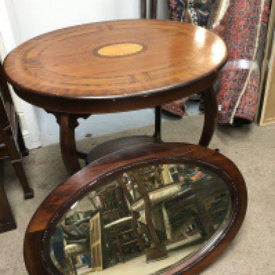 An Edwardian inlaid mahogany table, approx diameter 76cm and a mahogany framed wall mirror (2).
