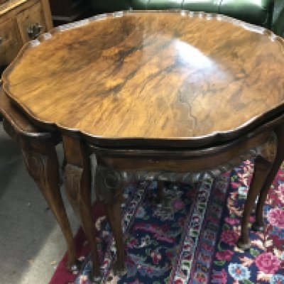 A nest of walnut tables , dimensions 75cm wide 52cm tall