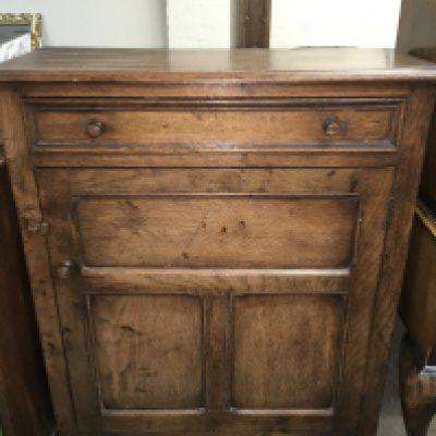 A carved oak side table with a single drawer, dimensions 86cm tall 76cm wide 32cm deep