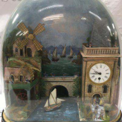 An automaton rocking ship, watermill windmill , moving town folk figures under dome . Seen working . Approximately 50cm wide 54cm tall