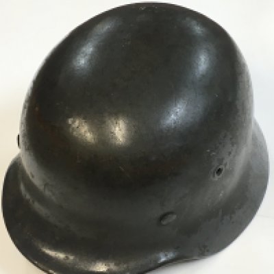 A WW2 German helmet with remnants of a decal. Postage cat c