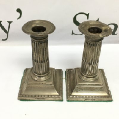 A pair of hallmarked silver column candle stick holders. Approximately 13cm and approximately 600g