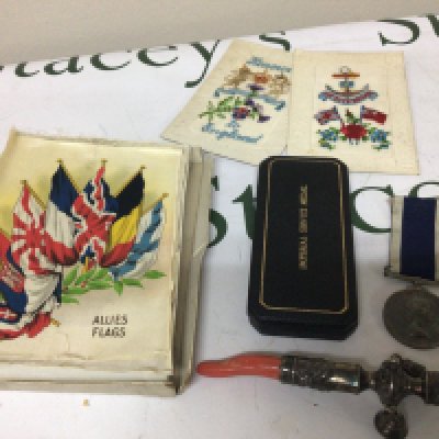 An Antique Silver Childs rattle with applied coral a collection of silk large size flags Allies Flags by BDV cigarettes two I world war silk post cards An Elizabeth II Long Service and good conduct medal Mx 849933 LS Rowe PO CK HMS Jaguar. and an Imperial Service Medal George VI.