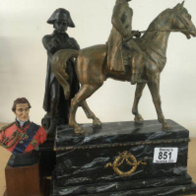 A brass figure of Napoleon on horse back mounted on a simulated marble base Together with a bronzed figure of Napoleon and a small bust of Wellington .