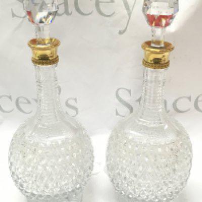 A pair of fine quality 18ct gold rim and cut glass Asprey decanters ,33cm tall. This lot cannot be posted