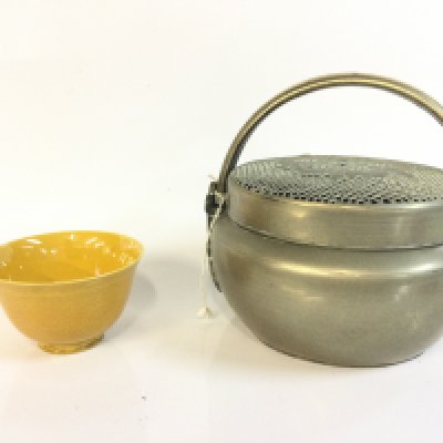 A Chinese hand warmer and a yellow glaze bowl. 5 and 15 cm tall. This lot cannot be posted