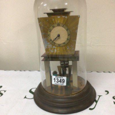 An Art Deco German Anniversary clock under a glass dome with metal pillars dome no damage clock for restoration.Height 32cm.