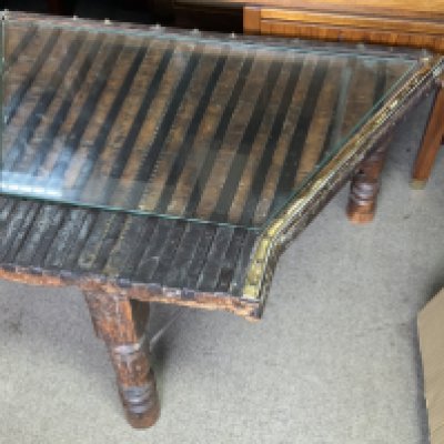 An Indonesian metal bound hardwood stand. 59cm x 94cm x 38cm.