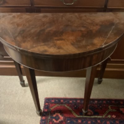 A George III mahogany demi-lune card table.