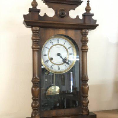 A German Rapport Wall clock with key and pendulum , 23cm tall approximately. This lot cannot be posted- NO RESERVE