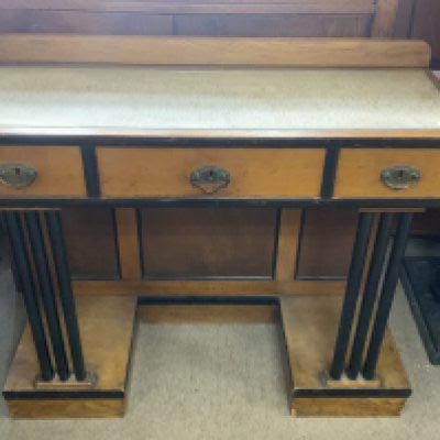 A small golden oak art deco hall table with ebonized pillars and draw frames. 90cm x 34.5cm x 79cm