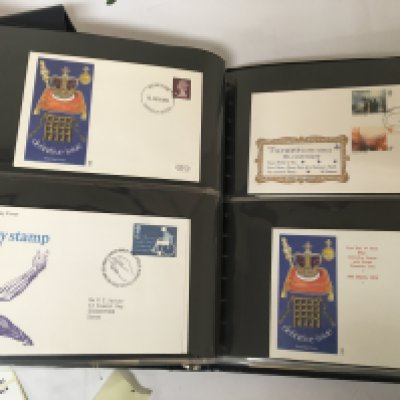 A box containing a collection of well presented first day covers in albums including Channel Islands.- NO RESERVE
