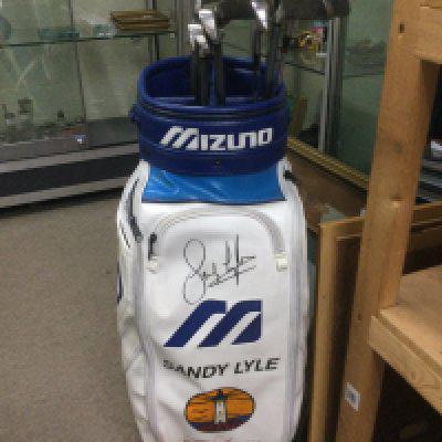 A golf bag signed by Sandy Lyle and containing various clubs plus three more golf related items signed by Sandy (4).