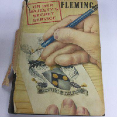 A first edition of Ian Fleming's On Her Majesty's Secret Service. Dust jacket torn.