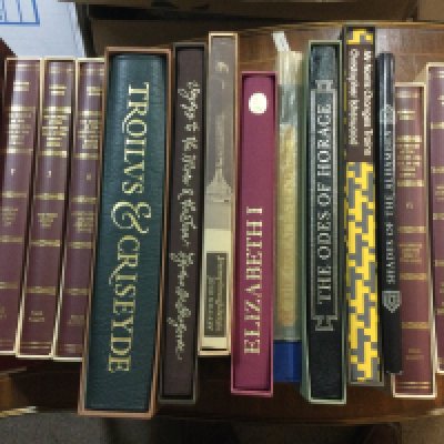 A box containing books including folio Society.