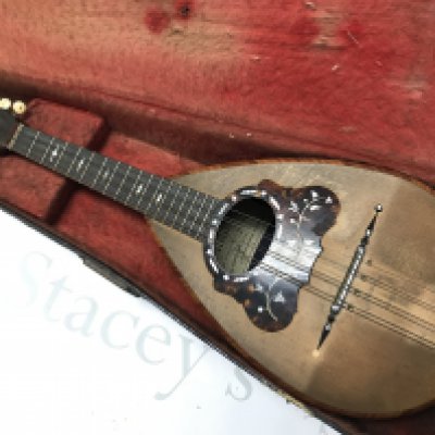 A Neapolitan Mandolin by Umberto Ceccherini, circa 1881 , 62cm long approximately. Label reads umberto ceccherini fabbrica di mandolini e mandole napoli premiate all esposizione di milano 1881 sole agents alban voigt & co 14 edmund place london. Postage category C