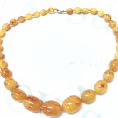 A butterscotch amber necklace , 70g , 63cm . Postage category A