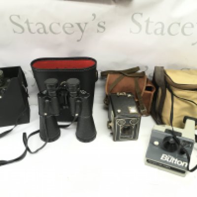 Two sets of binoculars and two vintage cameras including a Kodak Brownie and a Polaroid. Postage B