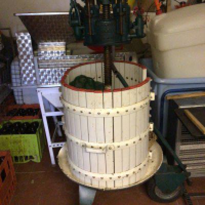 A large Martinetto Rolex Tipo N-50 grape press on a trolley with wheels
