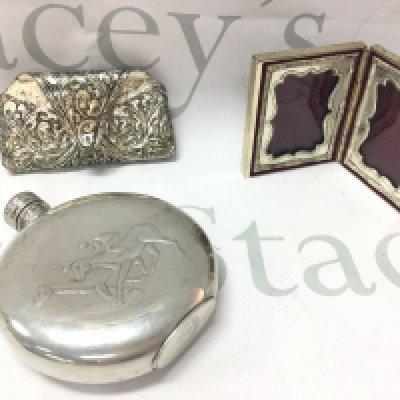 A small silver plate round hip flask decorated with two racehorses and a small heavy double photo frame embossed and a silver plated hanging item. Postage category B