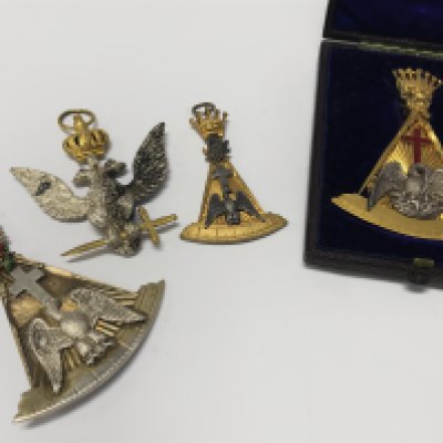 A cased gilt metal Masonic Regalia Rose Croix 18th degree jewel maker Joseph Strakley in a fitted case a similar silver rose Croix a 32nd degree eagle the reverse with date 1873 and one other Croix. Postage category A