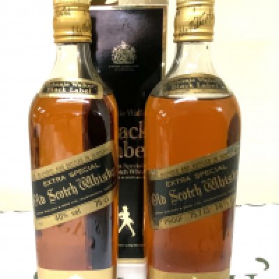 A vintage bottle of Johnnie Walker Black label together with a modern issue with box.