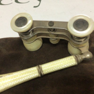 A pair of yellow enamelled Opera glasses some minor damage. Makers marks DRGM.