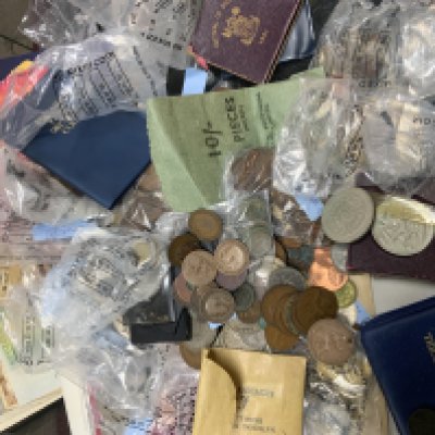 A mixed collection of British coins and banknotes.