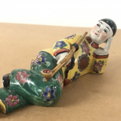 A Chinese Opium smoker porcelain figure 7.5cm tall 19.5cm long. Four character mark to base. This lot cannot be posted- NO RESERVE
