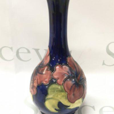 A Moorcroft Hibiscus vase, 21.5cm tall. No obvious damage or restoration, some crazing. This lot cannot be posted