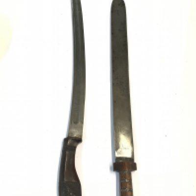 A Sumatran 19th century sword with carved hardwood grip the blade dated 1896 and a Bhutan sword with wired hardwood grip. (2)